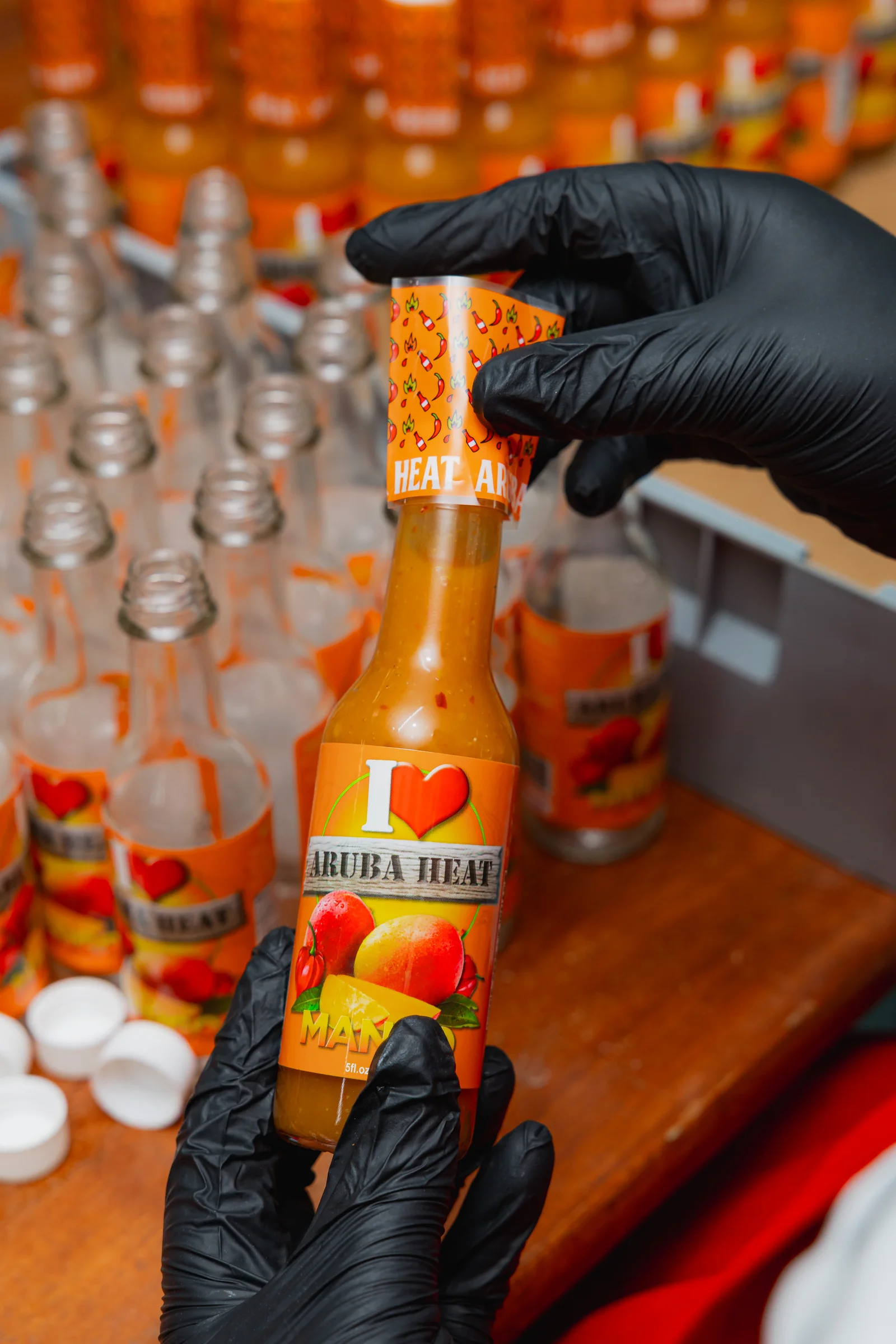 A bottle being labelled by hand